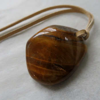 Tiger's eye, drilled stone on leather no.6