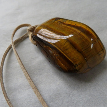 Tiger's eye, drilled stone on leather No. 10