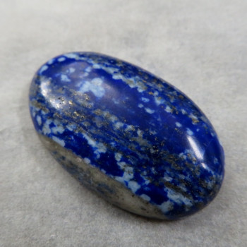 Lapis lazuli-spotted cabochon #1